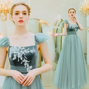Sage green princess dress with velvet bodice and white lace appliqué